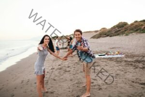 young-friends-having-good-time-beach