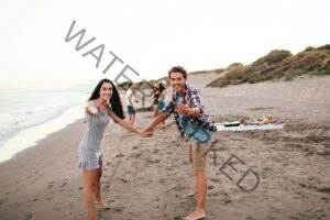 young-friends-having-good-time-beach
